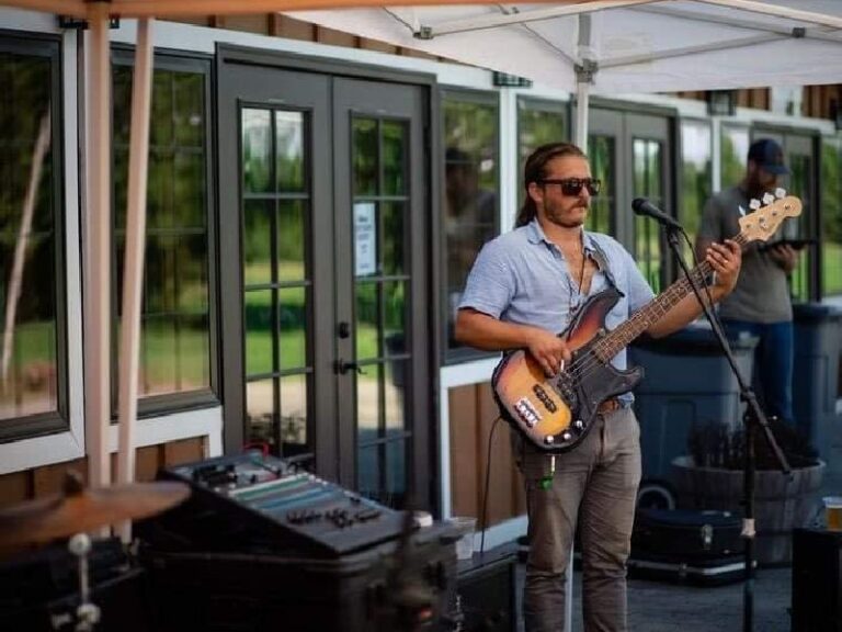 Alex playing bass outdoors at Henway