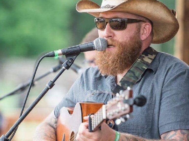 Logan singing and playing guitar on stage at Appaloosa Fest.