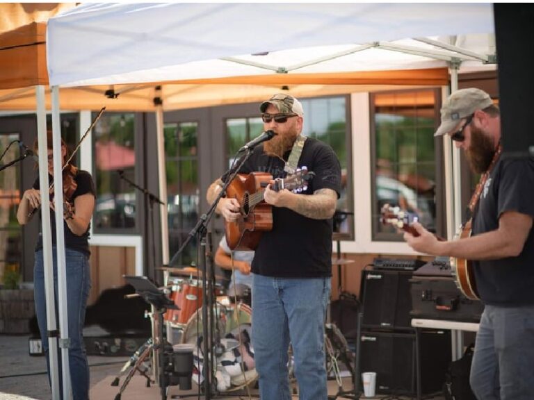 Stacey, Logan, and James performing outdoors at Henway Hard Cider