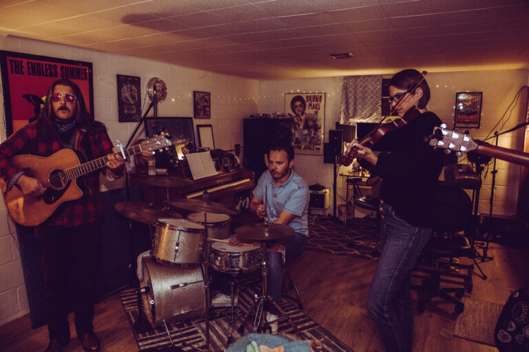 Alex, Riley, Stacey playing instruments in the basement