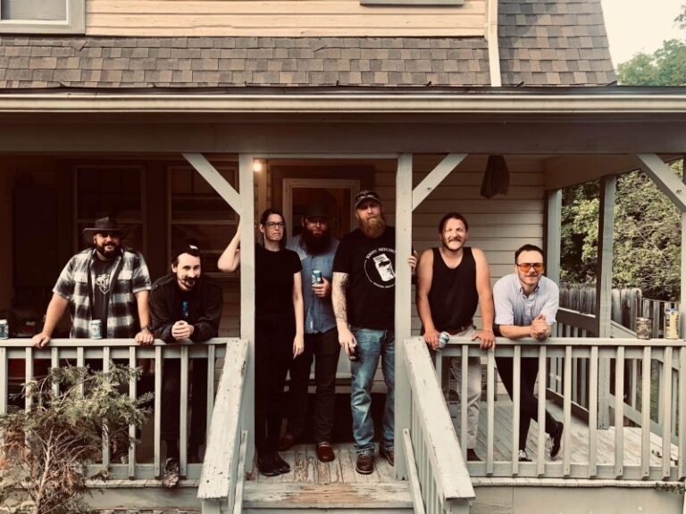 Low Water Bridge Band standing in a line on a porch outside the Barns of Rose Hill Green Room.