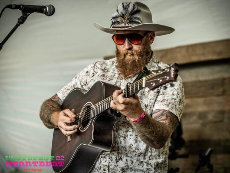 Logan playing guitar on stage at Floyd Fest 2022.