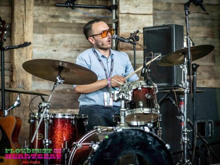 Riley playing drums on stage at Floyd Fest 2022.